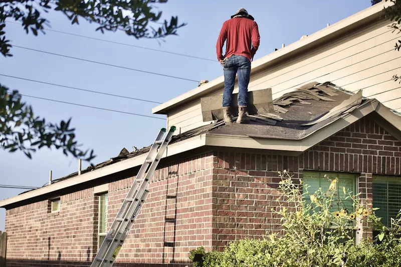 Professional roofer working on a residential roof in Governors Village